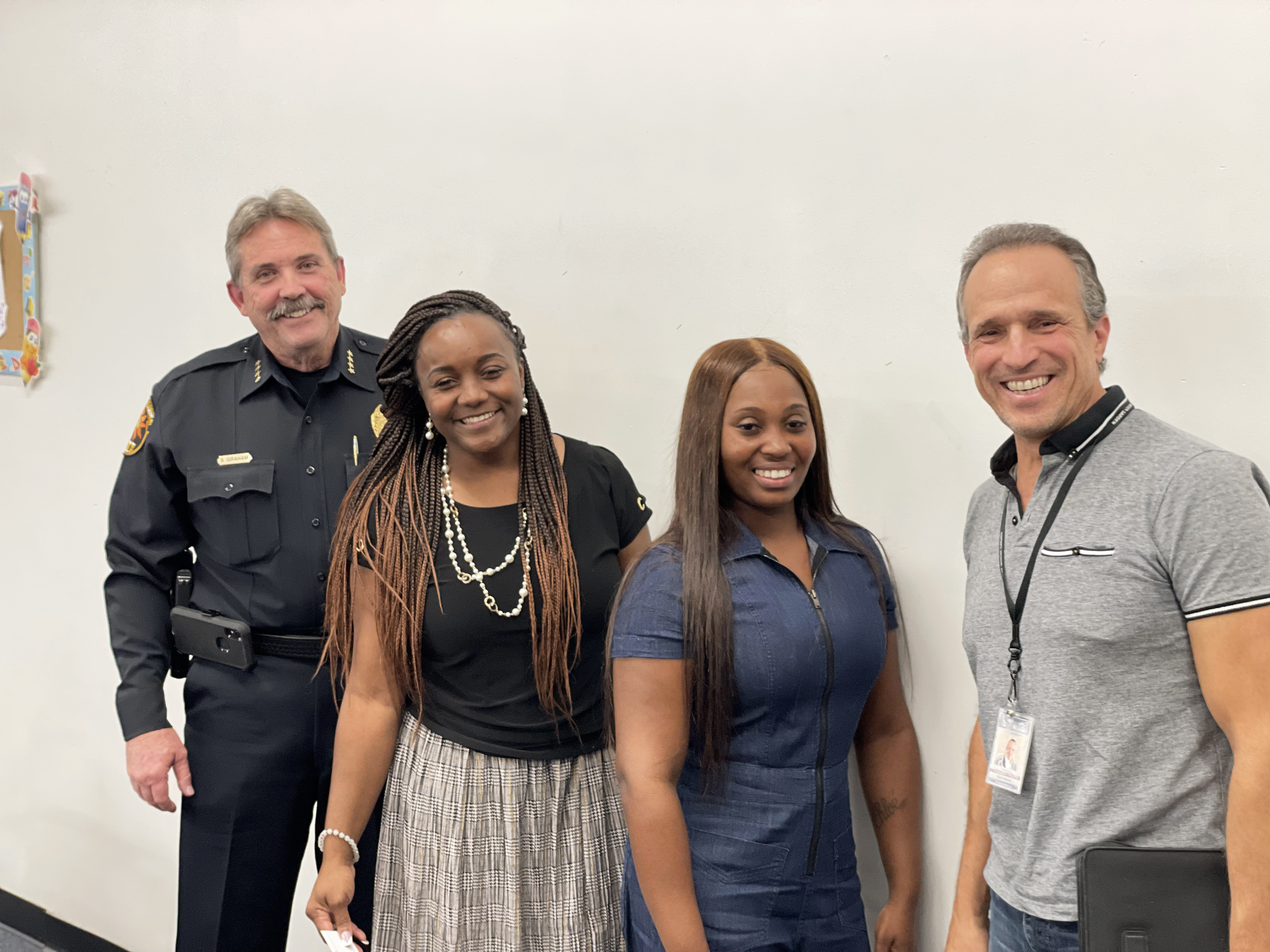 Chloe Johnson Brunson with chloe Johnson Brunson and Jamie Holley with Police Chief Steve Graham and Commissioner Mark Maciel