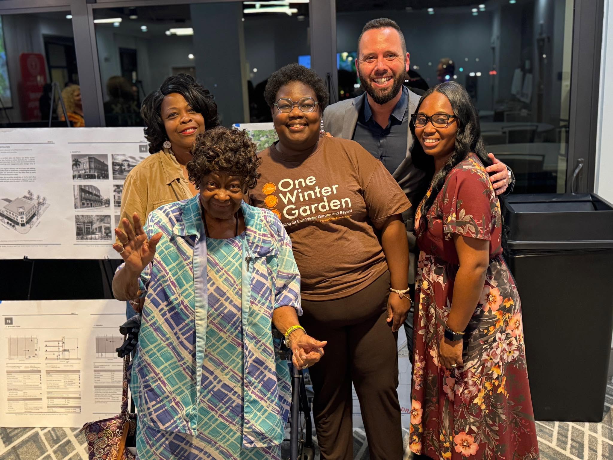 Austin Arthur with one Winter Garden team with neighbors in front of the community bus